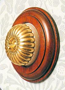 Arts & Crafts Movement style elegant fluted brass domed switch electric light switch on round mahogany wooden backplate