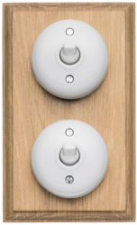Arts & Crafts Movement style white bakelite double light switch on light oak finish patress backplate
