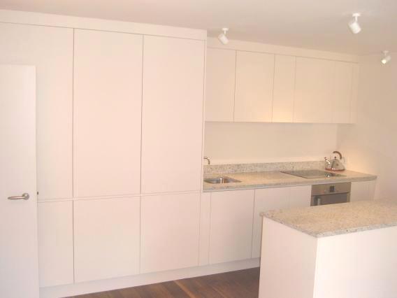 Cream lacquered minimalist fitted kitchen