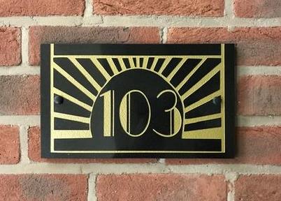 new Art Deco House number name sign with gold on brick wall