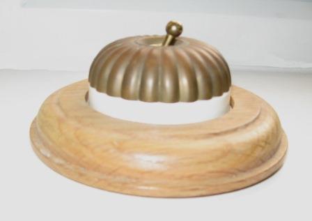 Arts & Crafts Movement style elegant fluted brass domed electric light switch on a square antique oak wooden backplate
