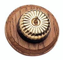 Arts & Crafts Movement style elegant fluted brass domed electric light switch on a round medium oak wooden backplate