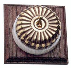 Arts & Crafts Movement style elegant fluted brass 4 domed electric light switch on antiqued oak wooden backplate