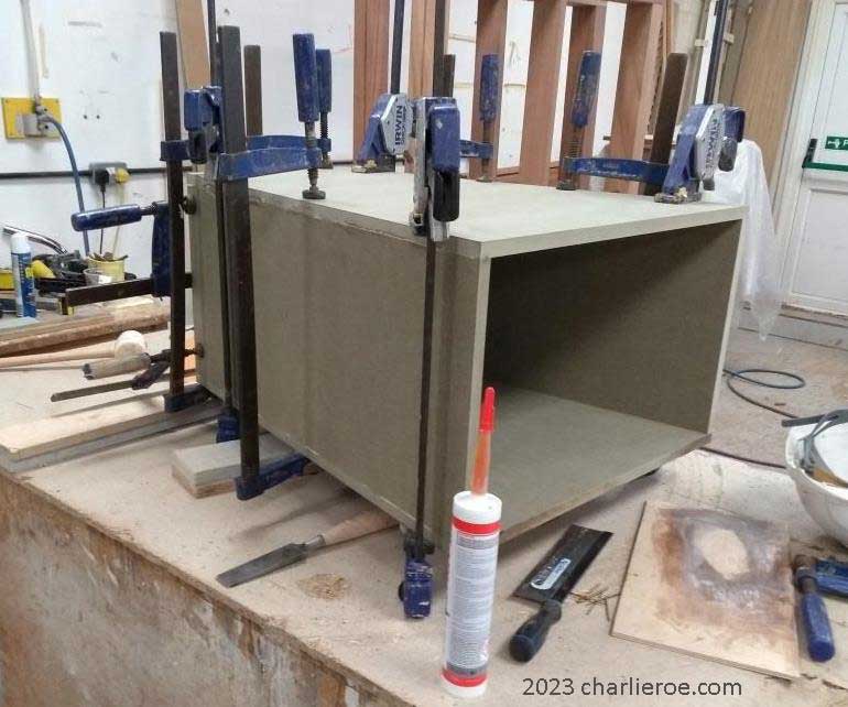 new ancient Egyptian Revival style Pylon shaped painted display console table being glued and clamped up