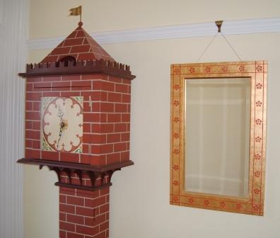 Painted Gothic 'Tower' grandfather clock beside a William Burges gold mirror frame